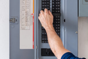 Electrician examining breaker box 