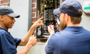 electricians working on residential breaker box