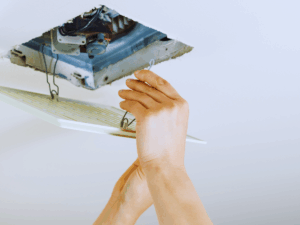 Electrician replacing noisy bathroom exhaust fan 