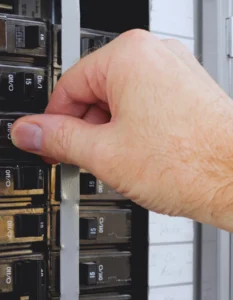 Homeowner resetting tripping circuit breaker