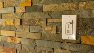 Wall-mounted dimmer light switch installed for adjustable indoor lighting control