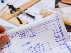 Electrician looking over home remodeling blueprint